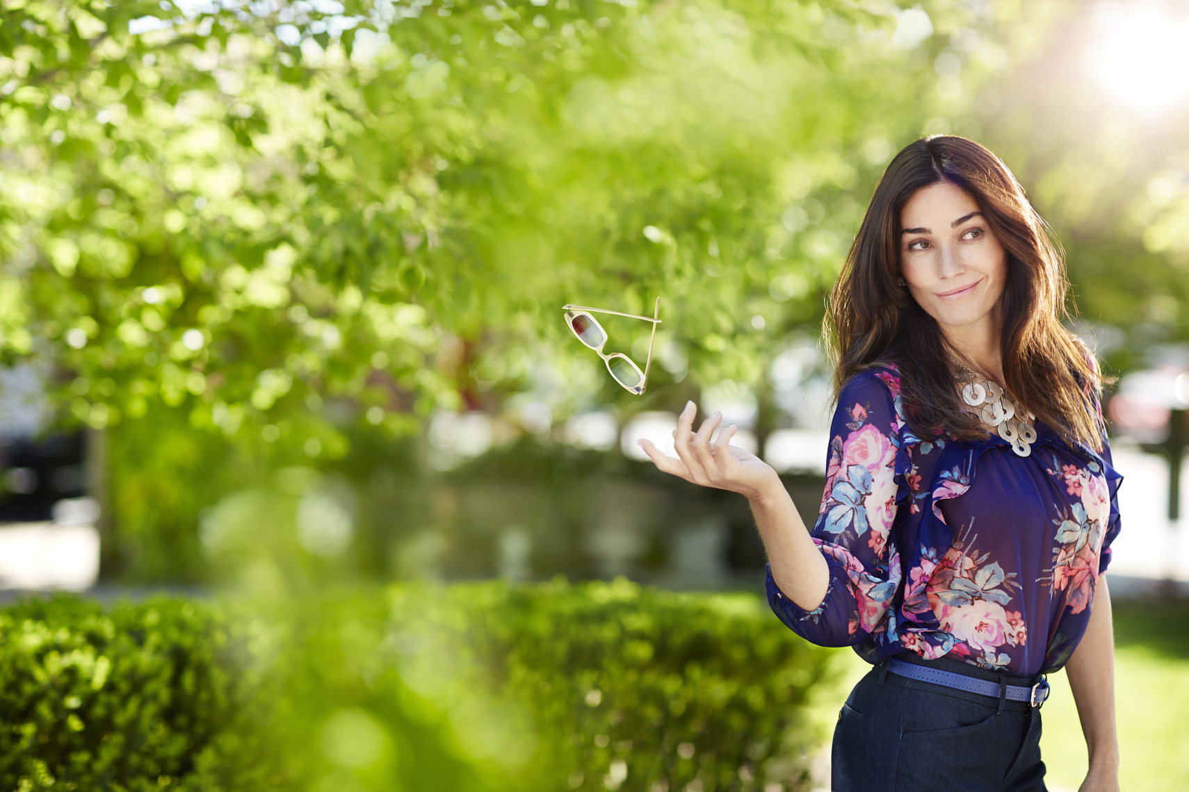 Beautiful woman tossing away her reading glasses